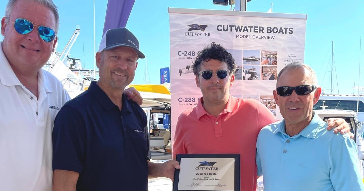 Clarks Landing Yacht Sales staff receiving award at boat show